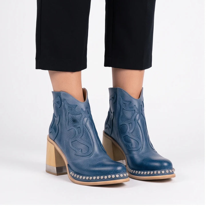 Model wearing Blue leather boots in a studio