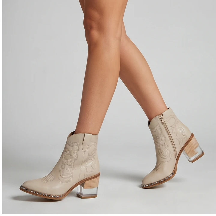 Model wearing White leather boots in a studio
