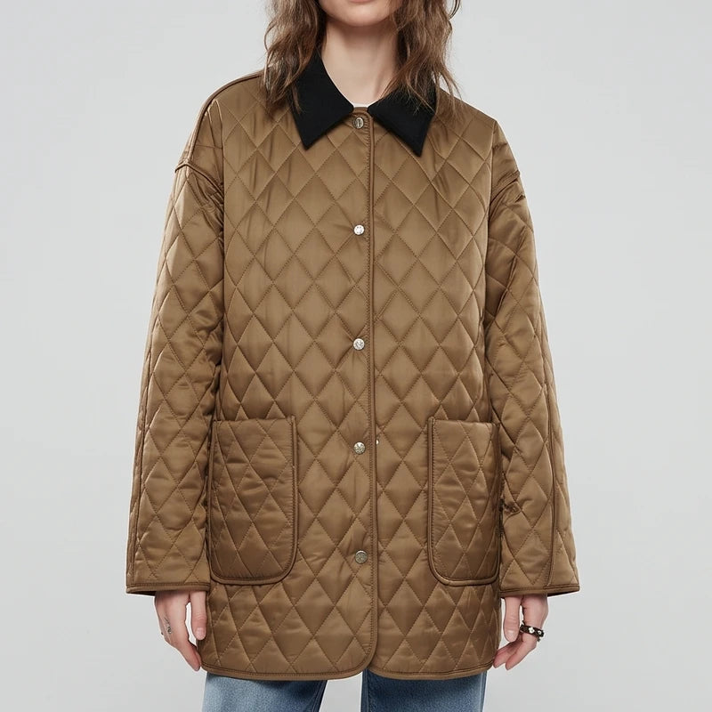 Woman wearing a relaxed-fit, quilted brown jacket with a black collar, front snap buttons, and two large pockets.