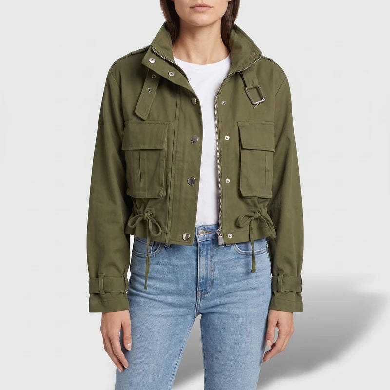 Green jacket on an off-gray studio background