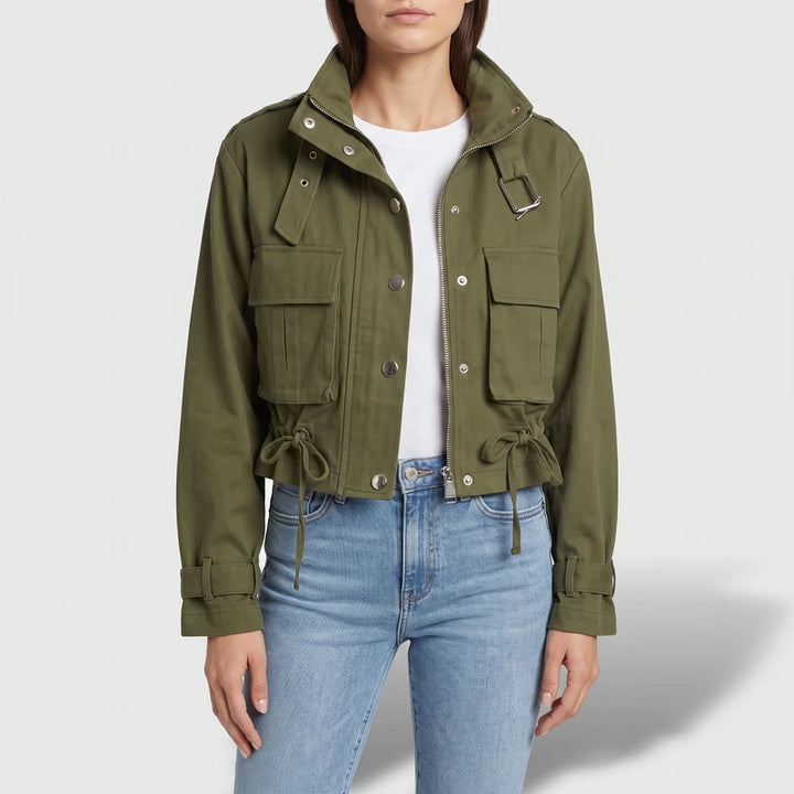 Green jacket on an off-gray studio background