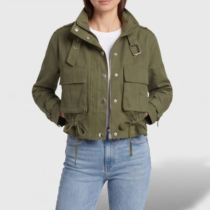 Green jacket on an off-gray studio background