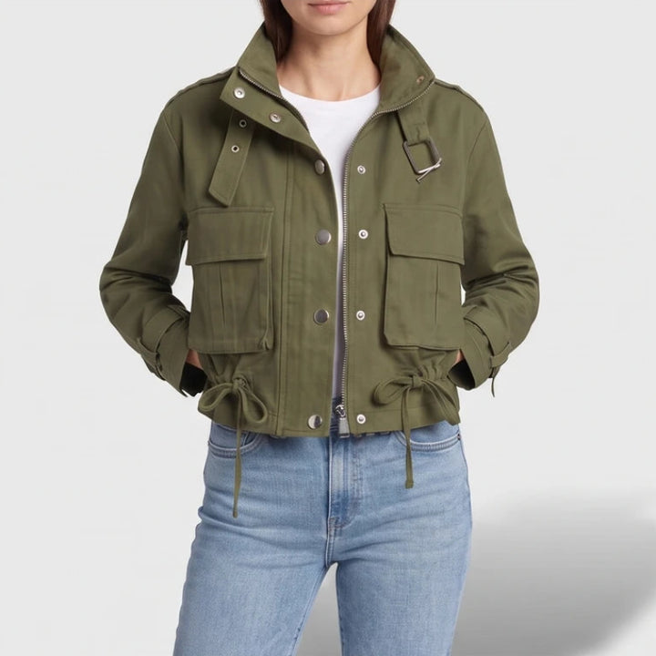 Green jacket on an off-gray studio background