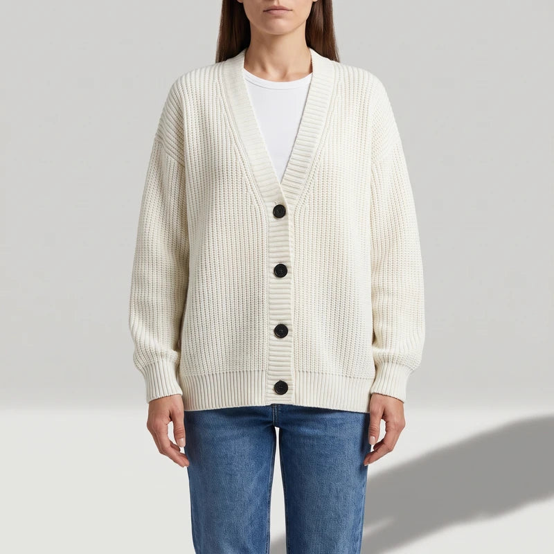 Beige knit cardigan on an off-gray studio background