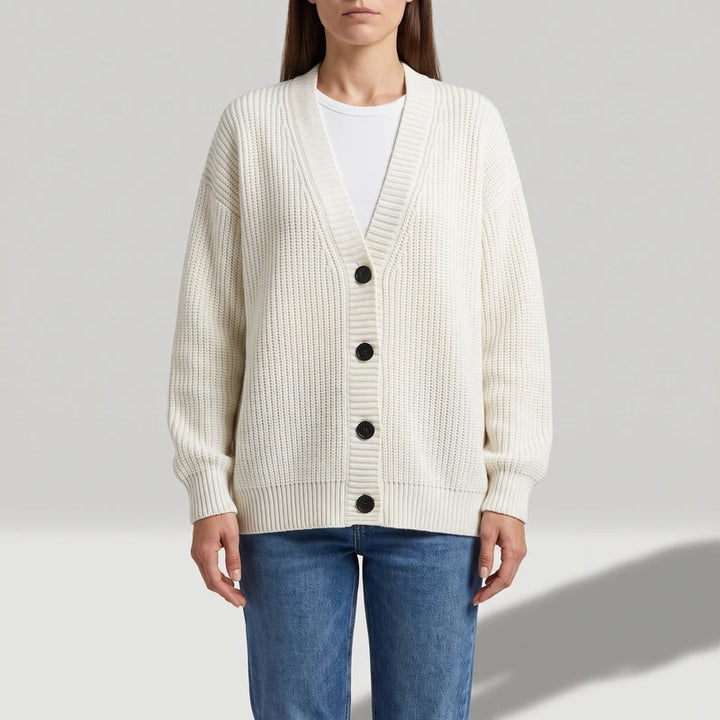 Beige knit cardigan on an off-gray studio background