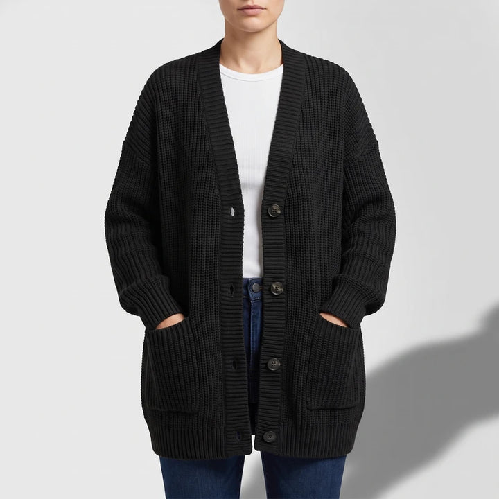 Black knit cardigan on an off-gray studio background