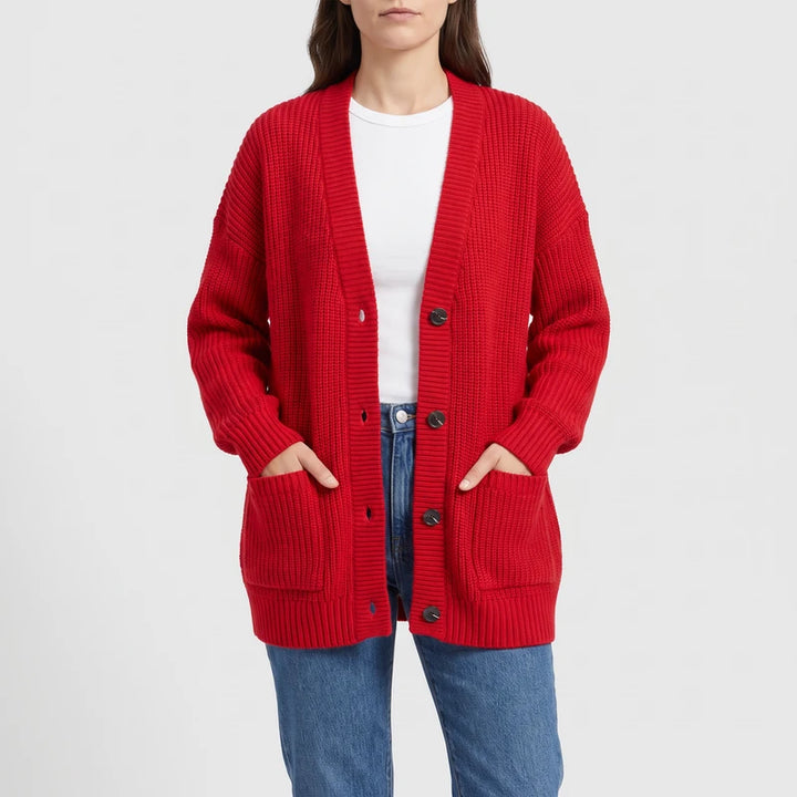 Red knit cardigan on an off-gray studio background
