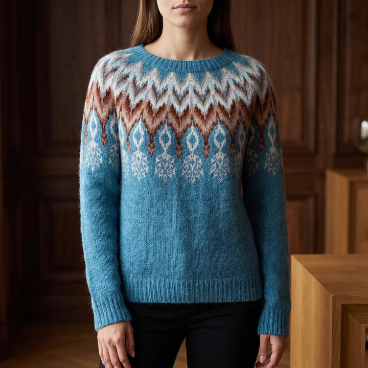Azure Feather sweater in a dark wood interior