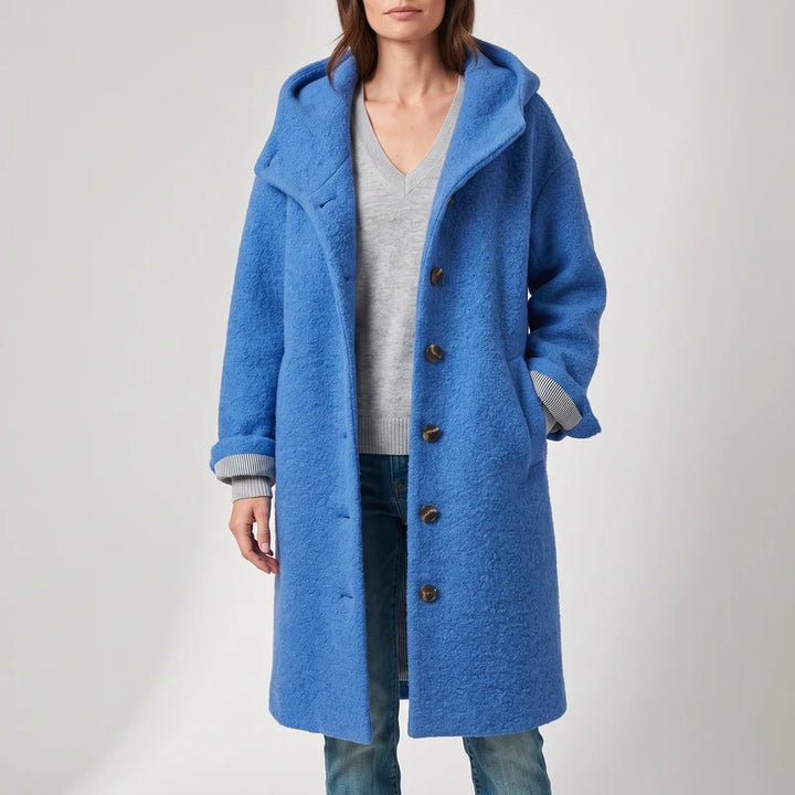 Blue coat on an off-gray studio background