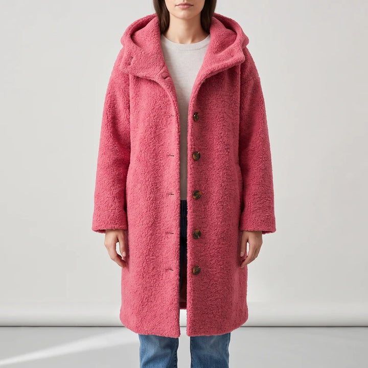 Pink coat on an off-gray studio background
