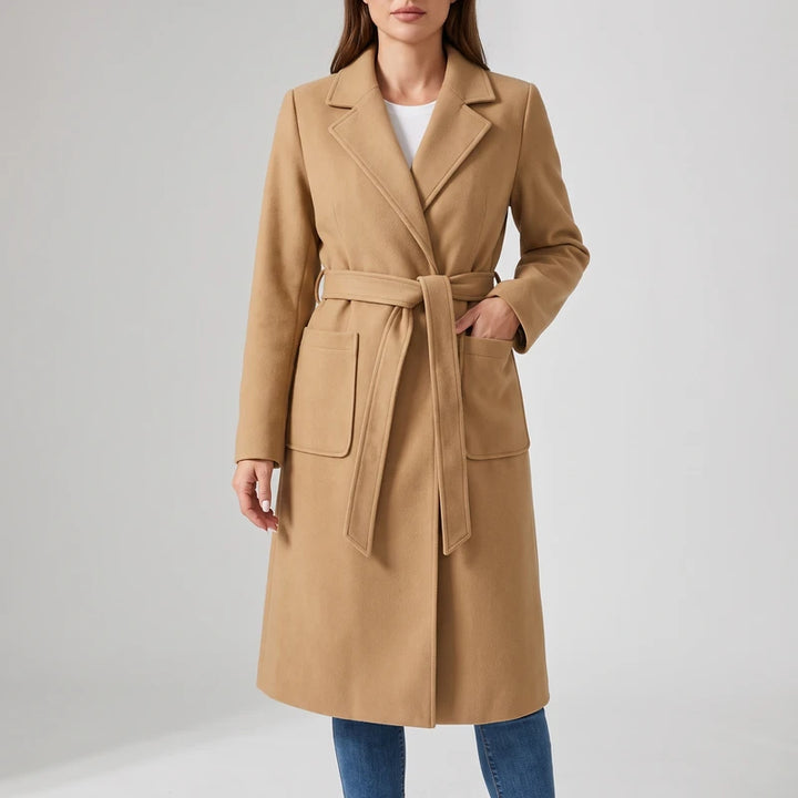 Camel wool coat on an off-gray studio background