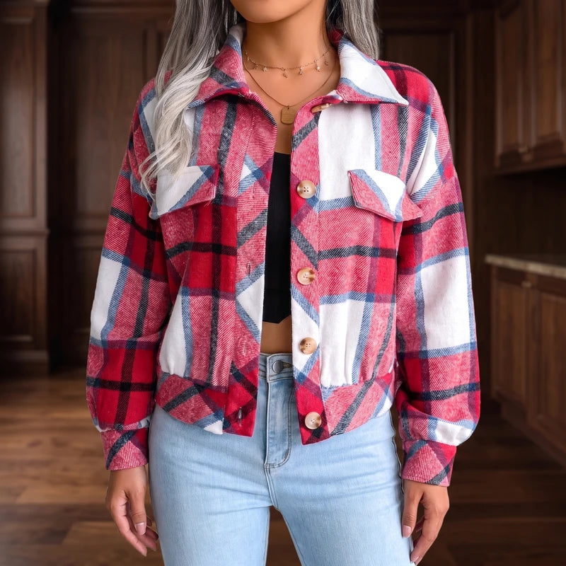 Woman wearing an open red, white, and blue plaid flannel jacket with elastic hem over a black top and light wash jeans.