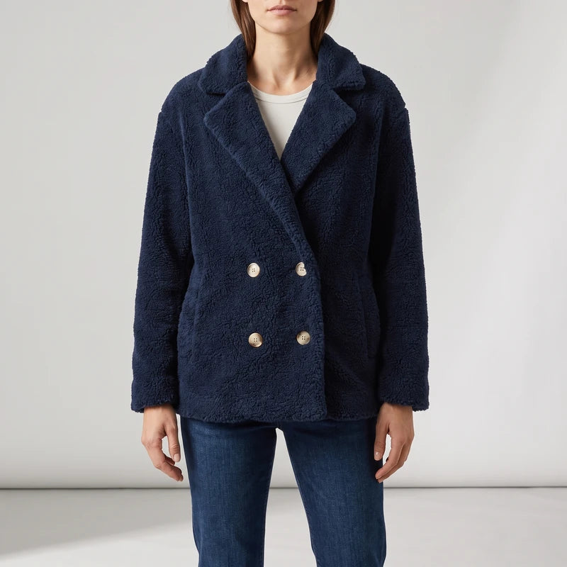 Navy wool blazer on an off-gray studio background