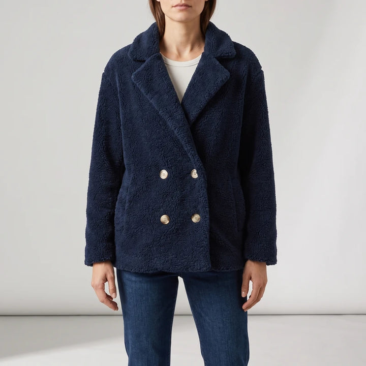 Navy wool blazer on an off-gray studio background
