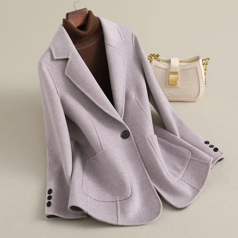 Light purple wool coat with notched lapels and large rounded pockets, revealing a brown turtleneck.