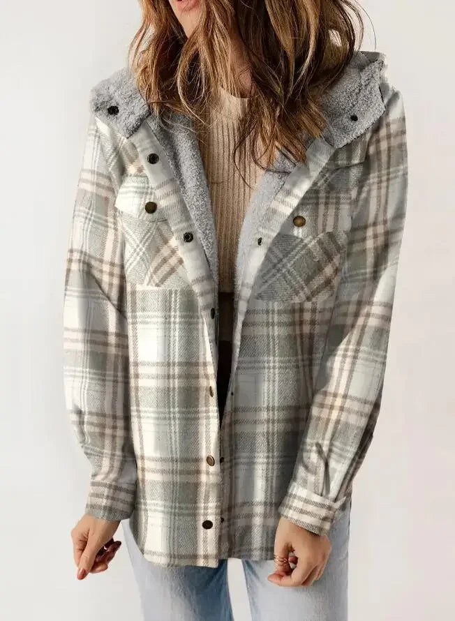 Woman wearing a relaxed-fit, hooded jacket with a light gray and cream plaid pattern over a neutral top.