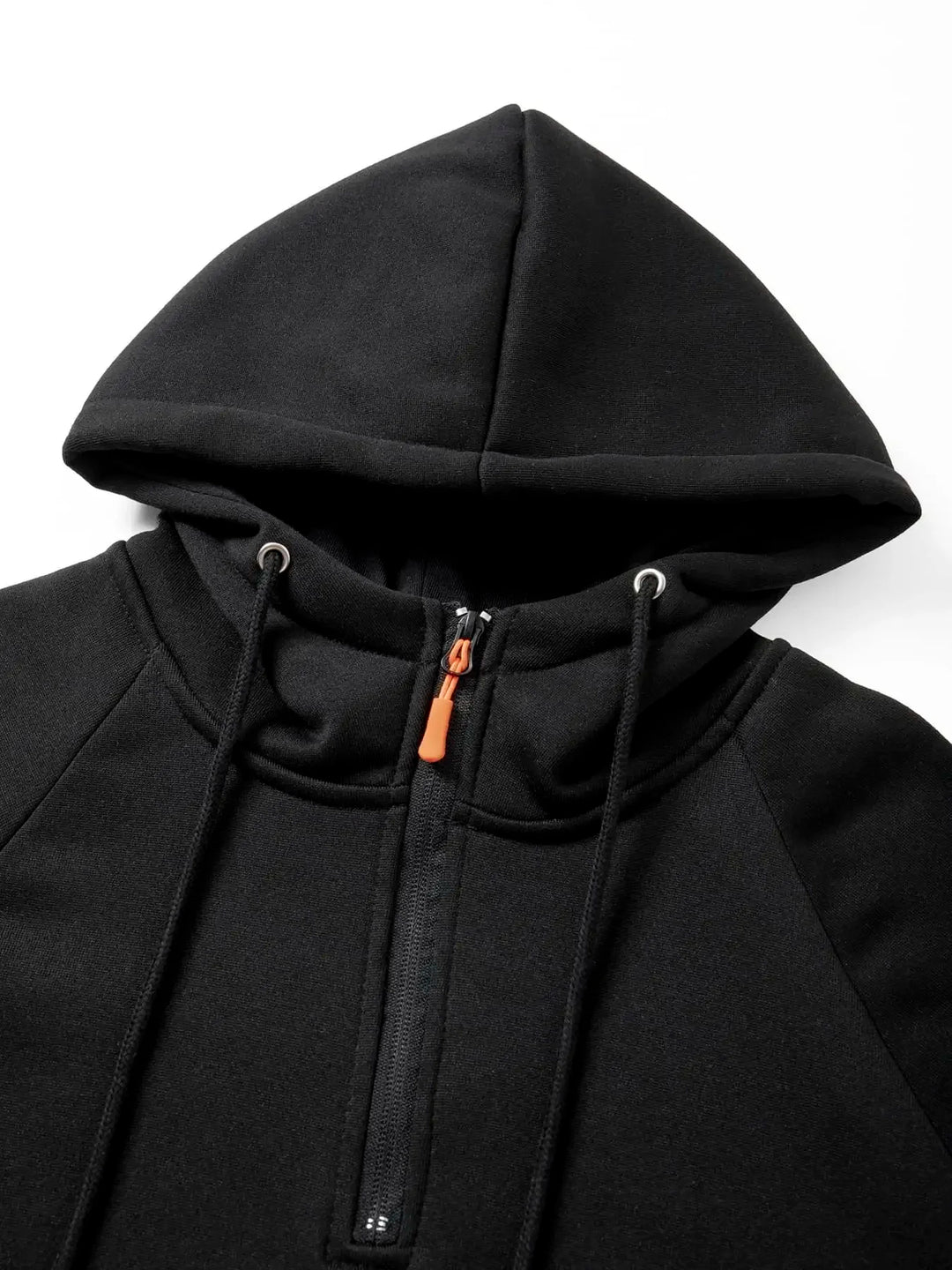 Close-up of a black fleece hoodie showing the hood, orange zipper pull, and black drawstring with silver eyelets.