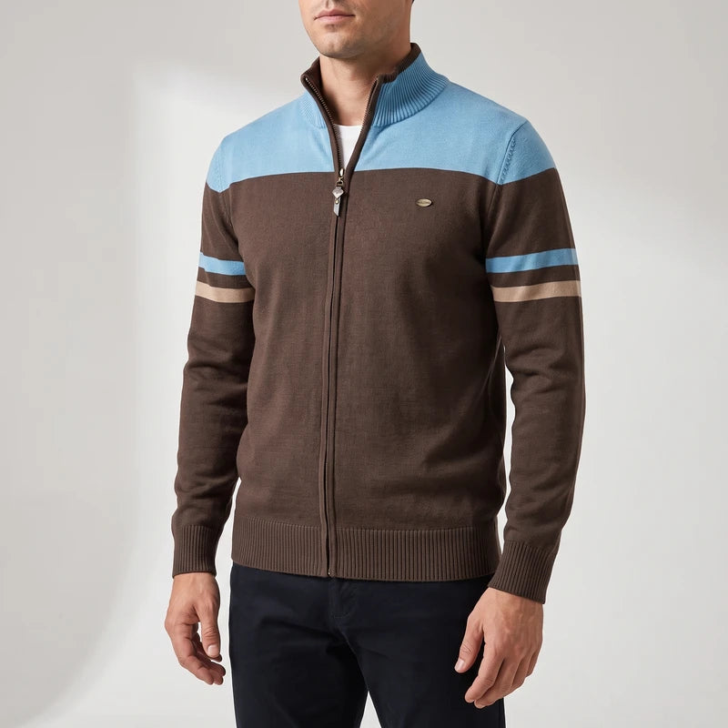 Man wearing a brown zip-up sweater with light blue and beige stripes on the chest and sleeves, against a white background.